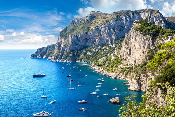 Capri's cliffs meet turquoise sea.